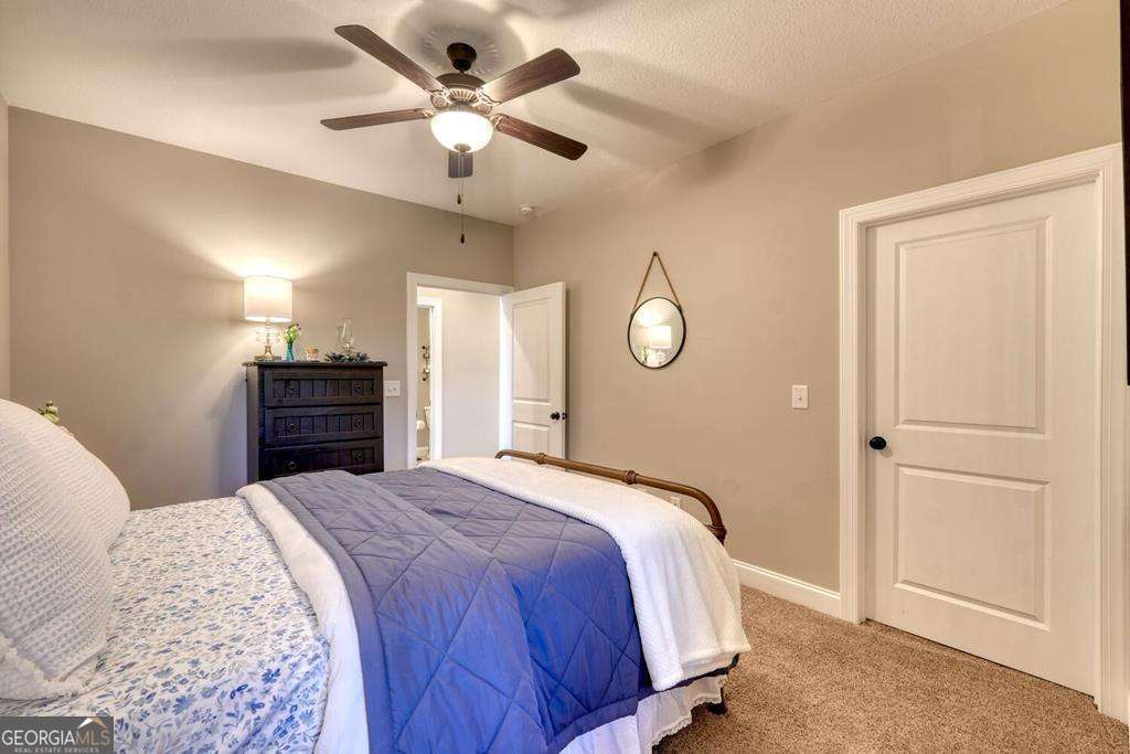 1309 Ridge Pointe Way, Unit 284 Blairsville, GA 30512 - Photo 30 of 75 a bedroom with a large bed and a chandelier