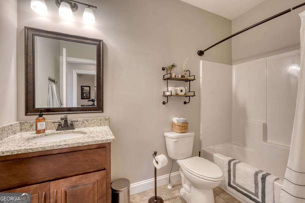 1309 Ridge Pointe Way, Unit 284 Blairsville, GA 30512 - Photo 31 of 75 a bathroom with a granite countertop sink toilet and mirror