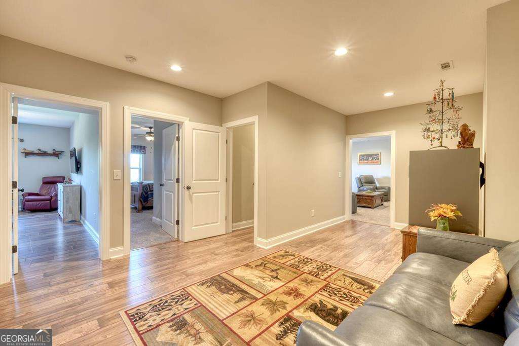 1309 Ridge Pointe Way, Unit 284 Blairsville, GA 30512 - Photo 34 of 75 a spacious bedroom with a bed and wooden floor