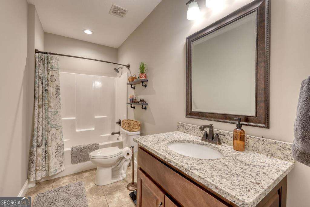 1309 Ridge Pointe Way, Unit 284 Blairsville, GA 30512 - Photo 40 of 75 a bathroom with a granite countertop sink toilet and shower