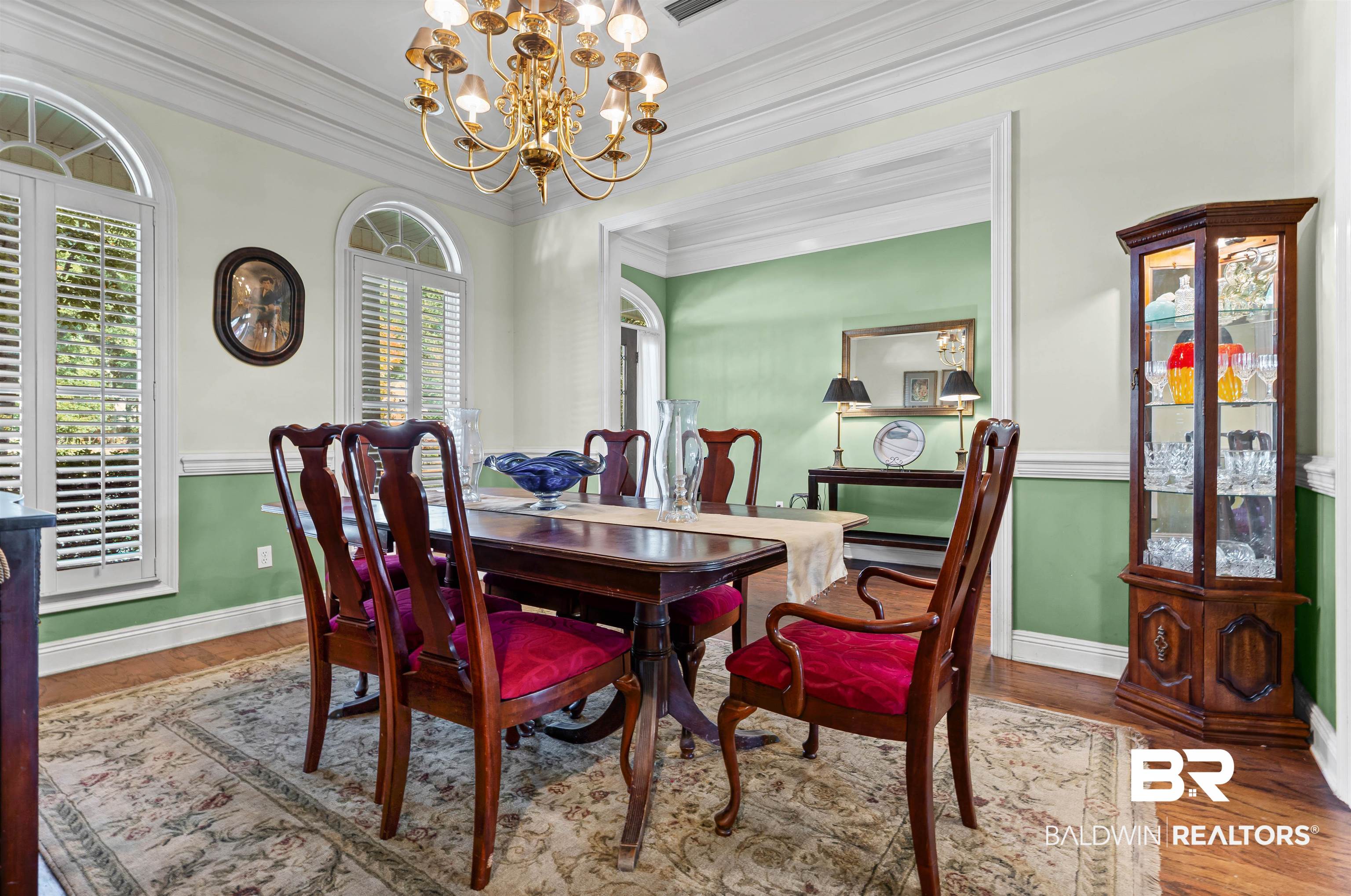 107 Beaver Dam Road Fairhope, AL 36532 - Photo 3 of 45 Dining area with crown molding, a chandelier, and wood finished floors