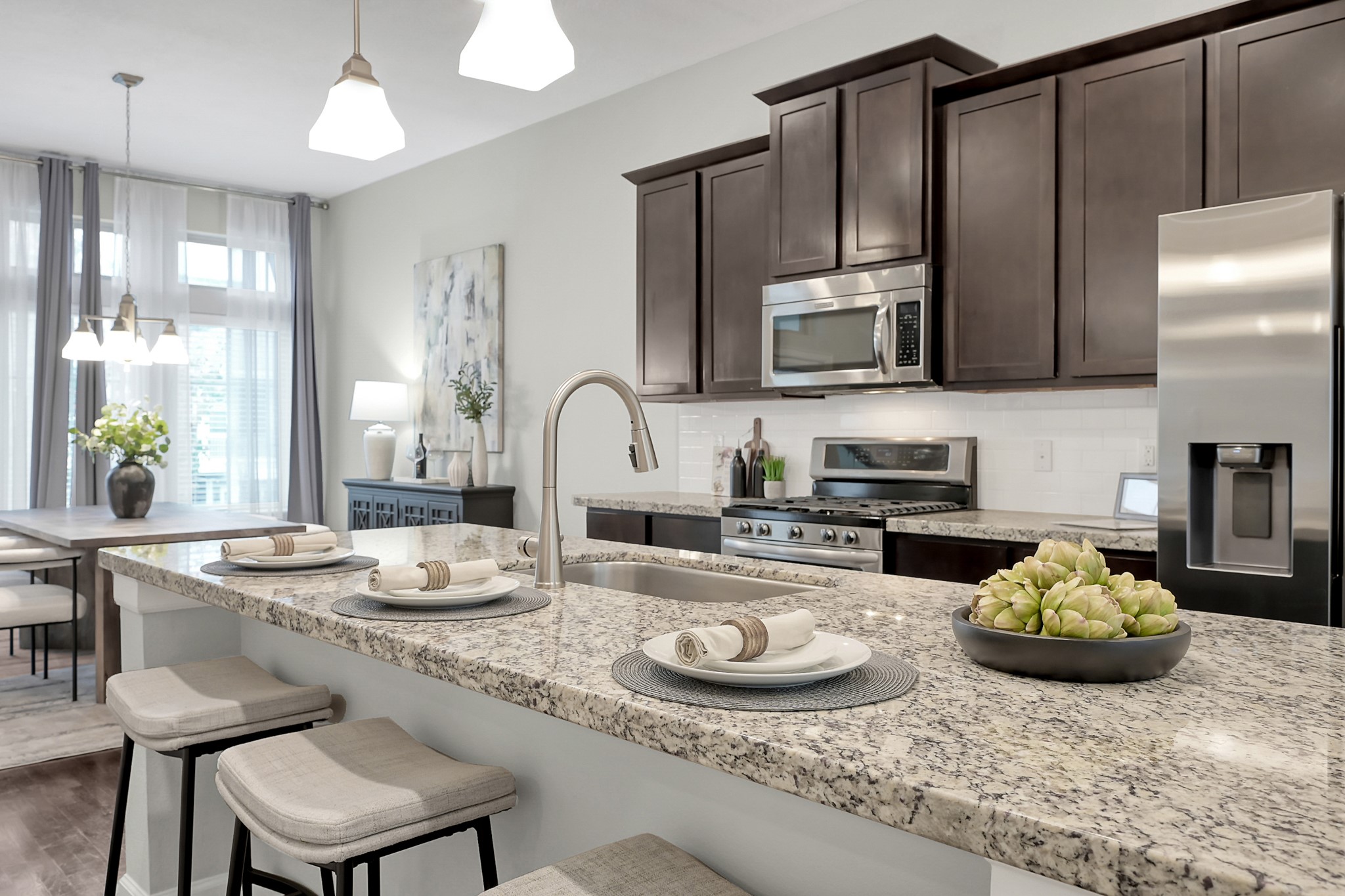 351 West 26th Street Houston, TX 77008 - Photo 11 of 45 This modern kitchen features a sleek breakfast bar with elegant granite countertops, perfect for casual dining and entertaining.