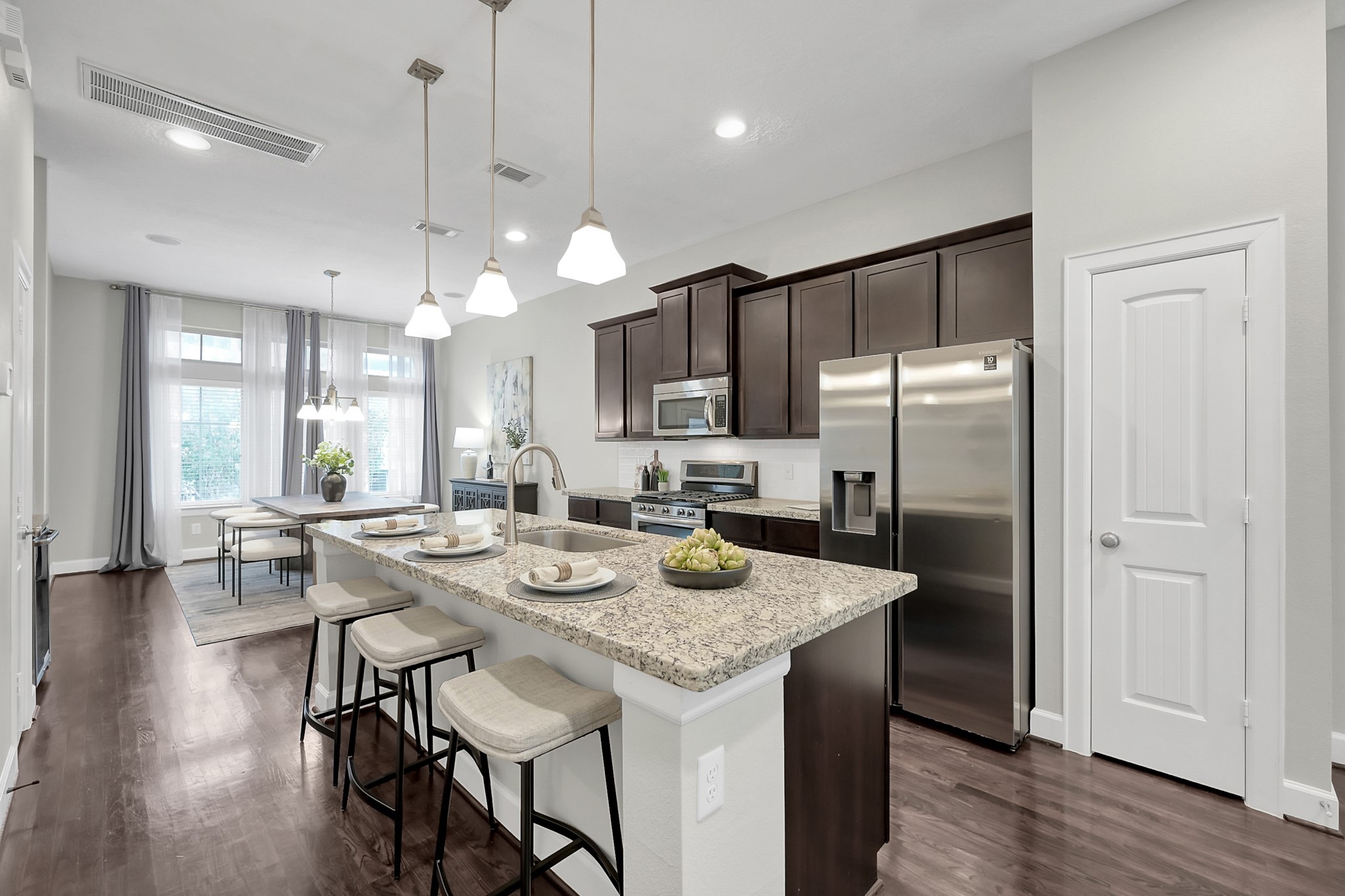 351 West 26th Street Houston, TX 77008 - Photo 15 of 45 The kitchen features a large island with pendant lighting and seating.