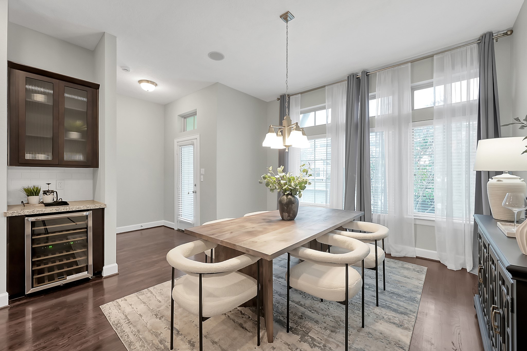 351 West 26th Street Houston, TX 77008 - Photo 19 of 45 Bright dining area with large windows and a modern light fixture. Includes a built-in wine cooler and cabinet for convenient storage.