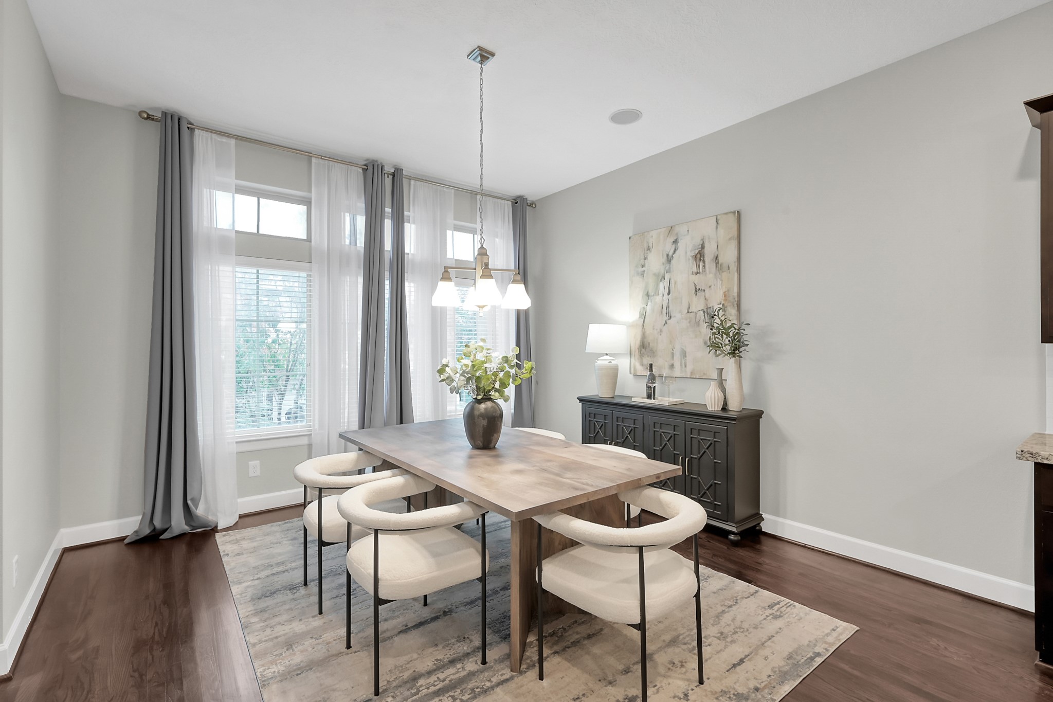 351 West 26th Street Houston, TX 77008 - Photo 20 of 45 Natural light streams through tall windows complementing the soft gray walls and dark hardwood floors.