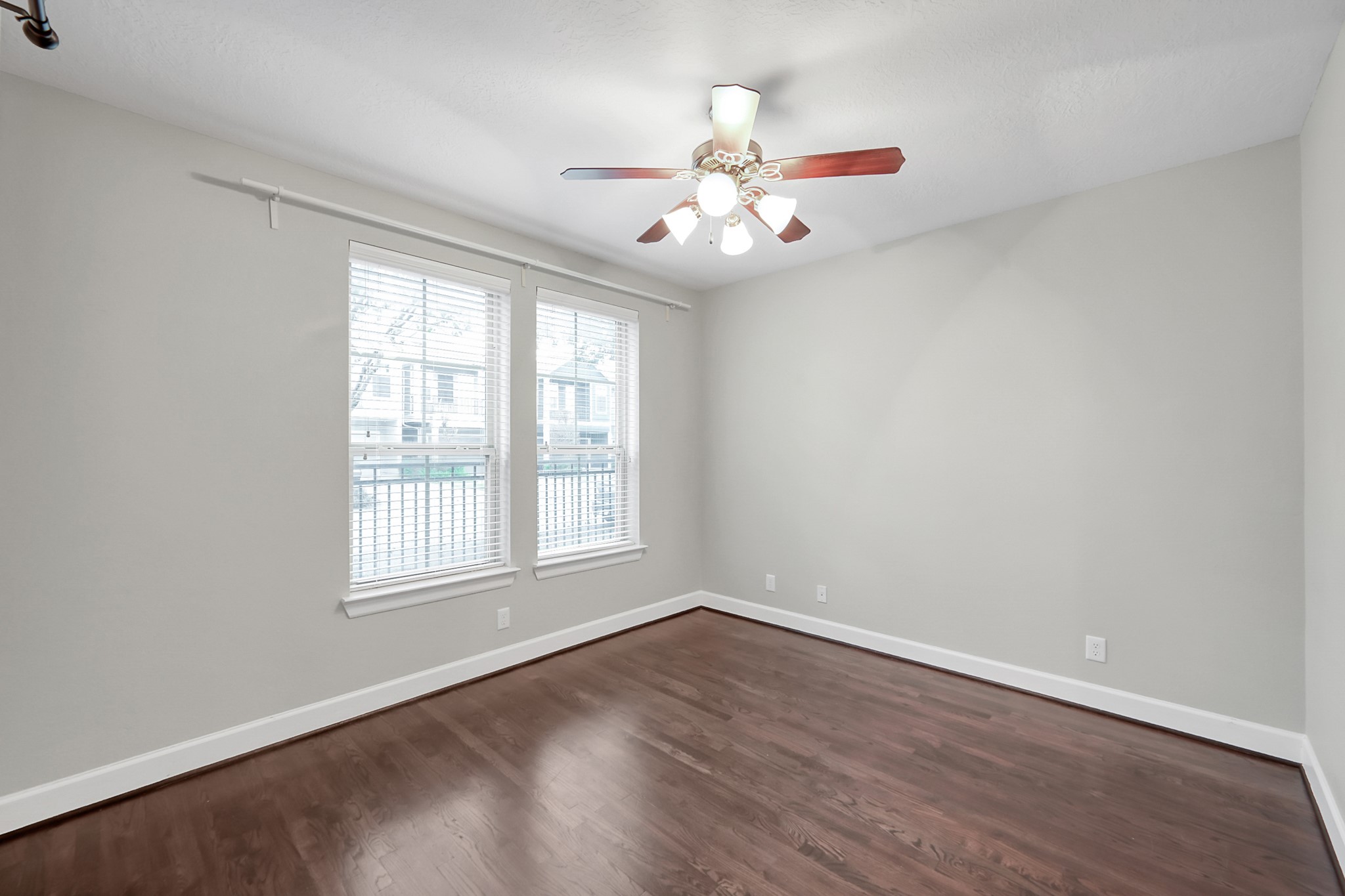 351 West 26th Street Houston, TX 77008 - Photo 34 of 45 This is a bright room with hardwood flooring, neutral walls, a ceiling fan, and two large windows for natural light. Ideal for a bedroom or home office.
