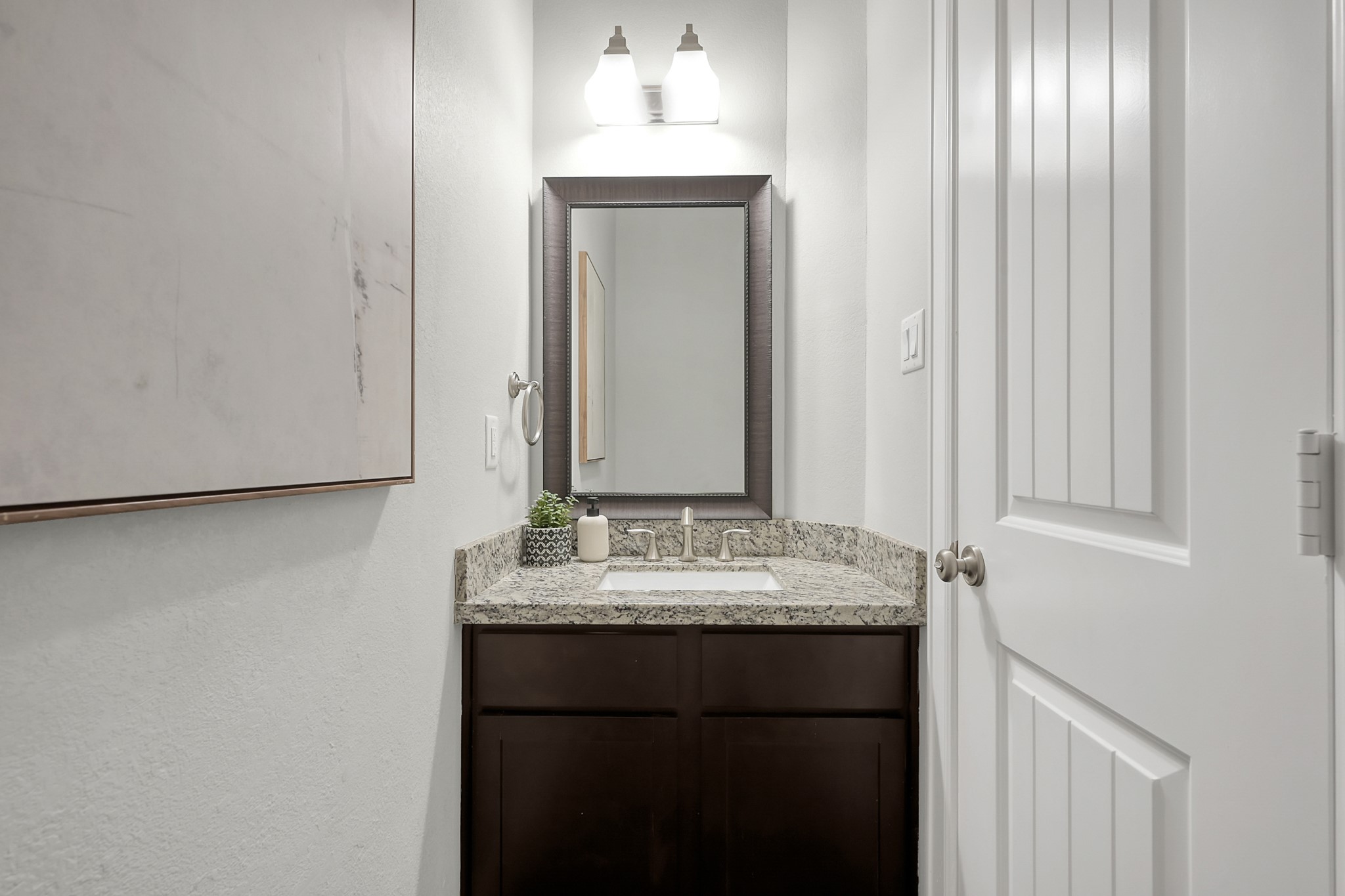 351 West 26th Street Houston, TX 77008 - Photo 37 of 45 This elegantly designed half bath features a sleek granite countertop, rich dark cabinetry, and ambient lighting, perfect for adding a touch of luxury to your home.