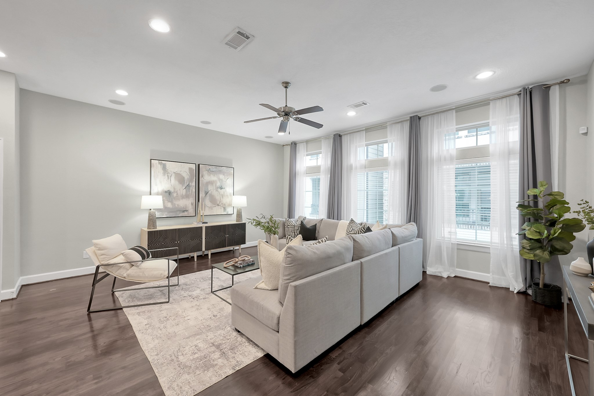 351 West 26th Street Houston, TX 77008 - Photo 6 of 45 This spacious living room is filled with abundant natural light from multiple windows, creating a cozy yet sophisticated atmosphere.