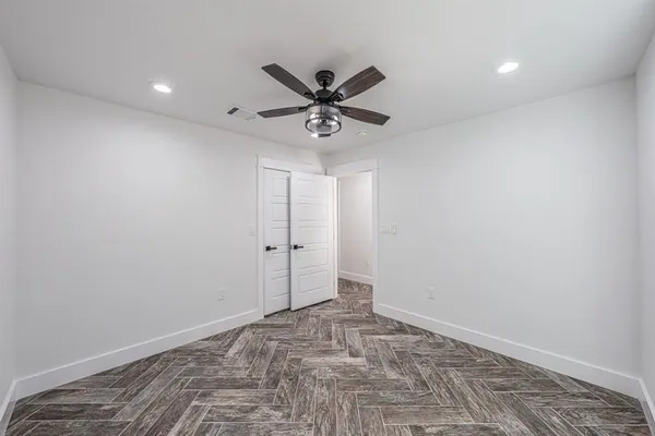 a bedroom with a bed and a potted plant