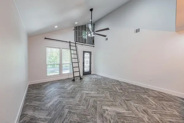 a living room with furniture a rug and a chandelier