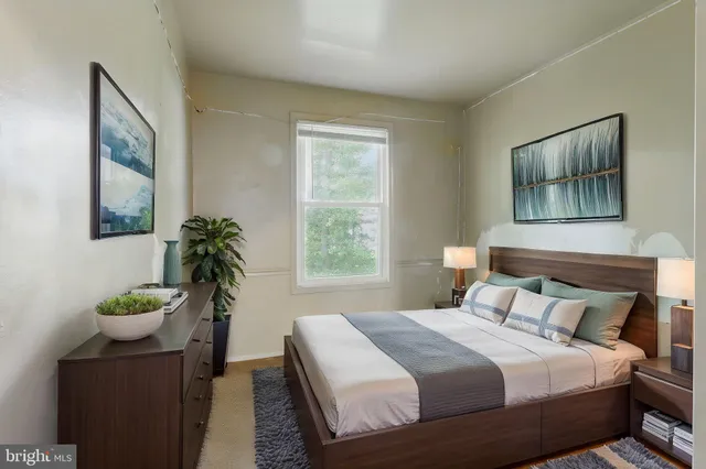 a bedroom with a bed and a potted plant