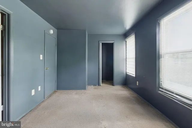 a view of a big room with windows and entryway