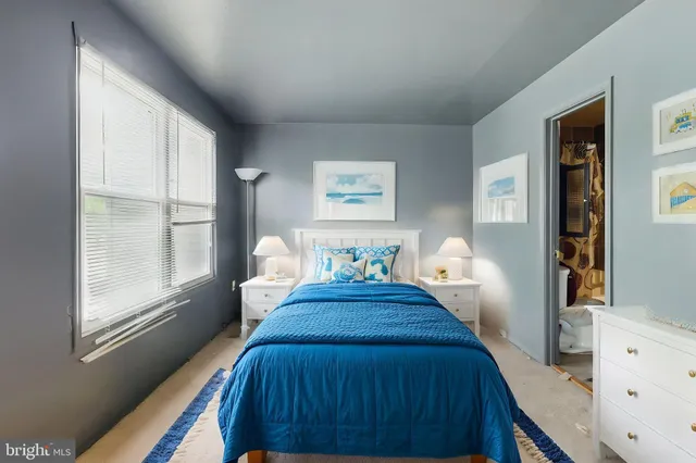 a view of a bedroom with wooden floor and windows