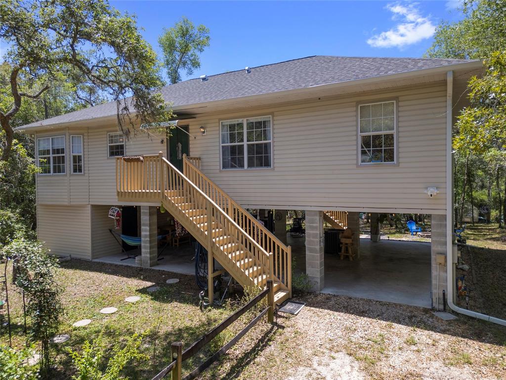 9019 Stone Drive Webster, FL 33597 - Photo 1 of 1 a front view of house with deck area and outdoor seating