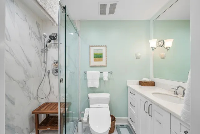a bathroom with a toilet a sink and mirror