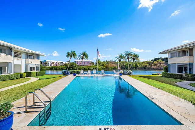 a view of a house with swimming pool and yard