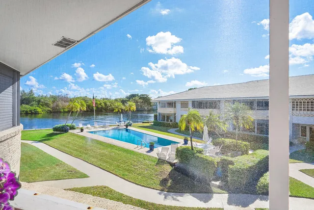 a view of a swimming pool with a patio and a garden
