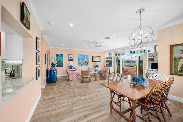 a view of a dining room with furniture wooden floor and chandelier