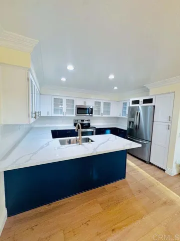 a view of kitchen with stainless steel appliances sink refrigerator and microwave