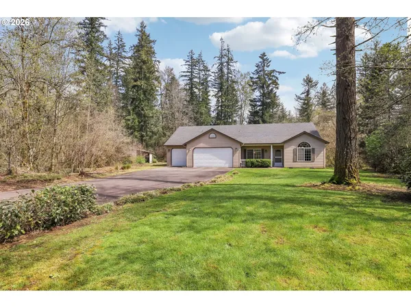 a house with green field in front of it