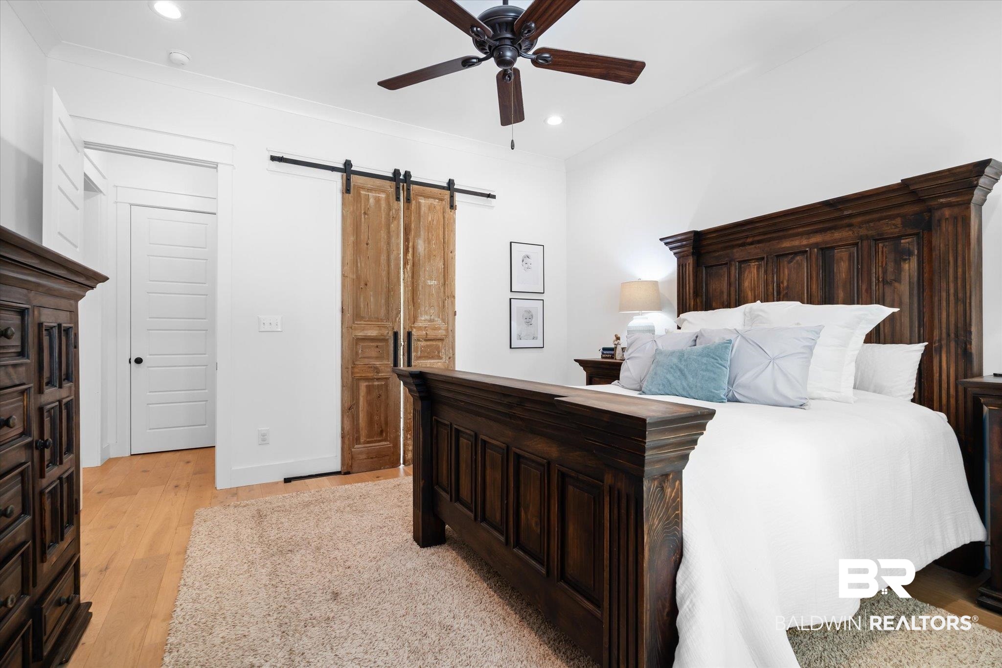 15 Semmes Avenue Mobile, AL 36604 - Photo 4 of 43 Bedroom featuring ceiling fan, light hardwood / wood-style floors, a barn door, and ornamental molding