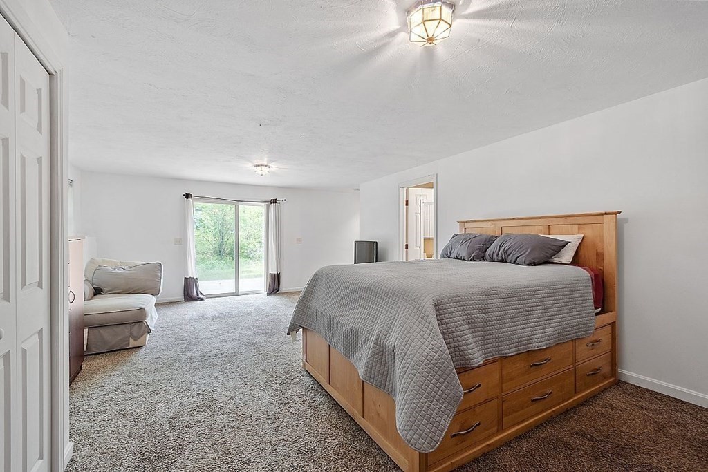 237 Spring Street Athol, MA 01331 - Photo 28 of 35 a spacious bedroom with a bed and a couch