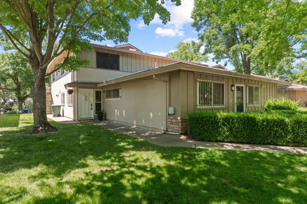 a front view of house with yard and green space