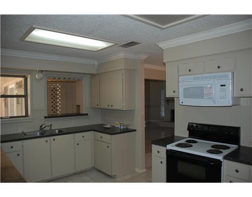 4929 Chatfield Drive Corpus Christi, TX 78413 - Photo 3 of 5 a kitchen with cabinets and window