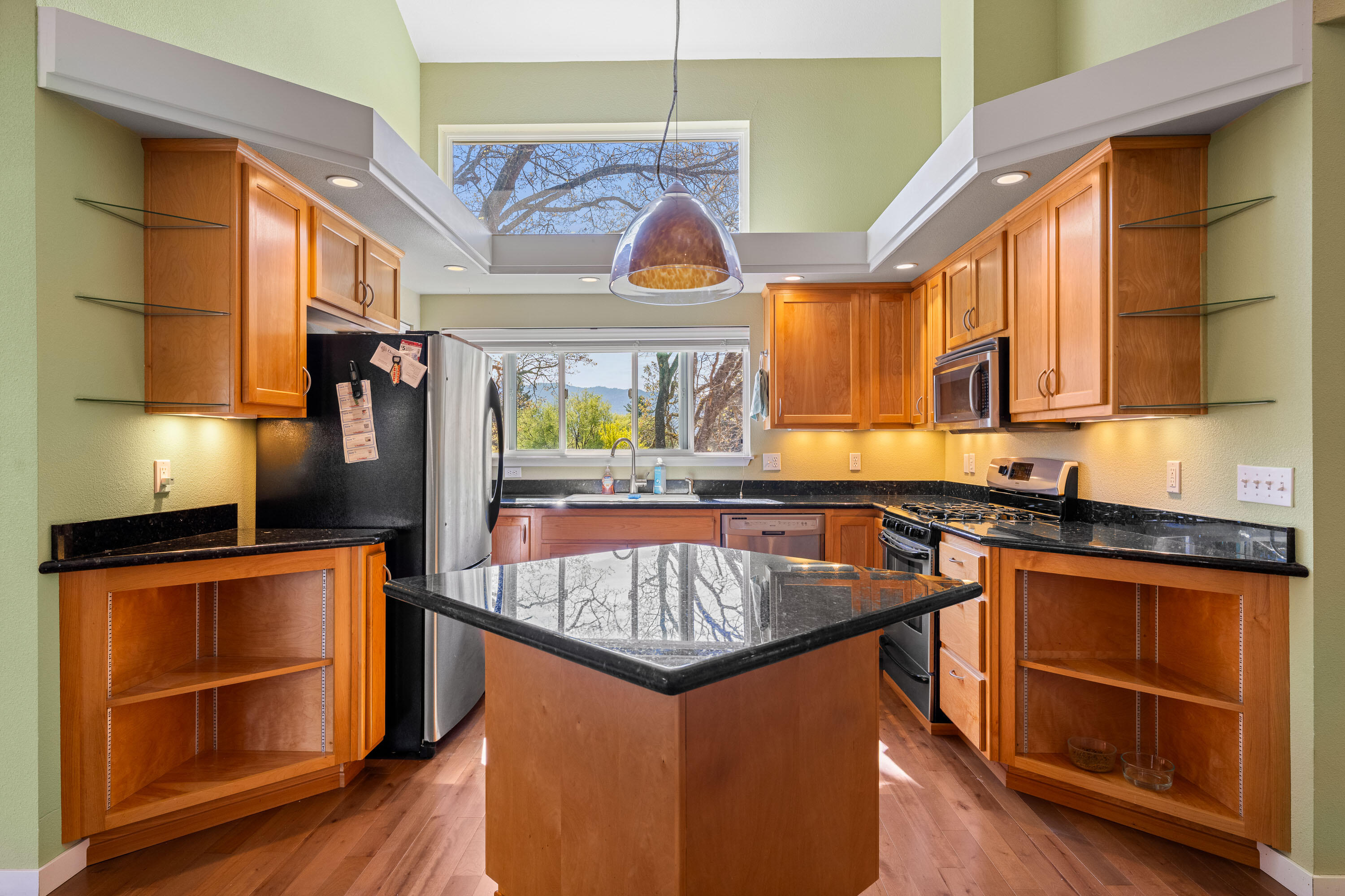 105 Cedar Ridge Terrace Rogue River, OR 97537 - Photo 3 of 23 a kitchen with stainless steel appliances granite countertop a stove a sink and a microwave