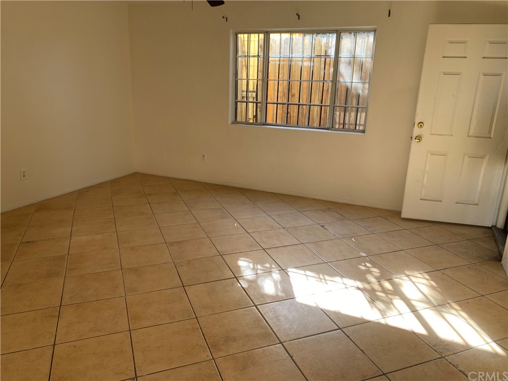 8420 South Broadway Los Angeles, CA 90003 - Photo 12 of 19 a view of a livingroom with an empty space and a window