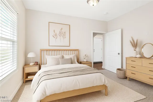 a bedroom with a bed and painting on the wall