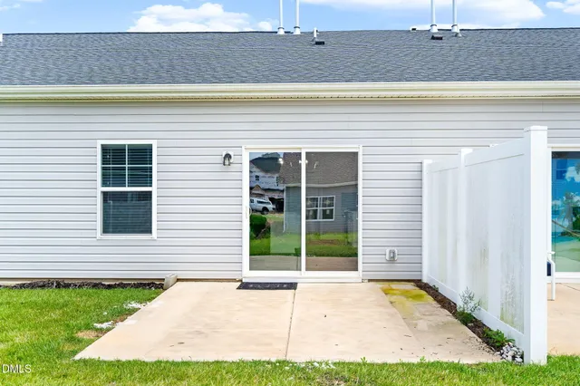 a view of a house with a backyard and a tub