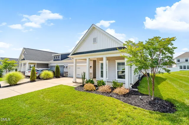 a front view of a house with garden and patio