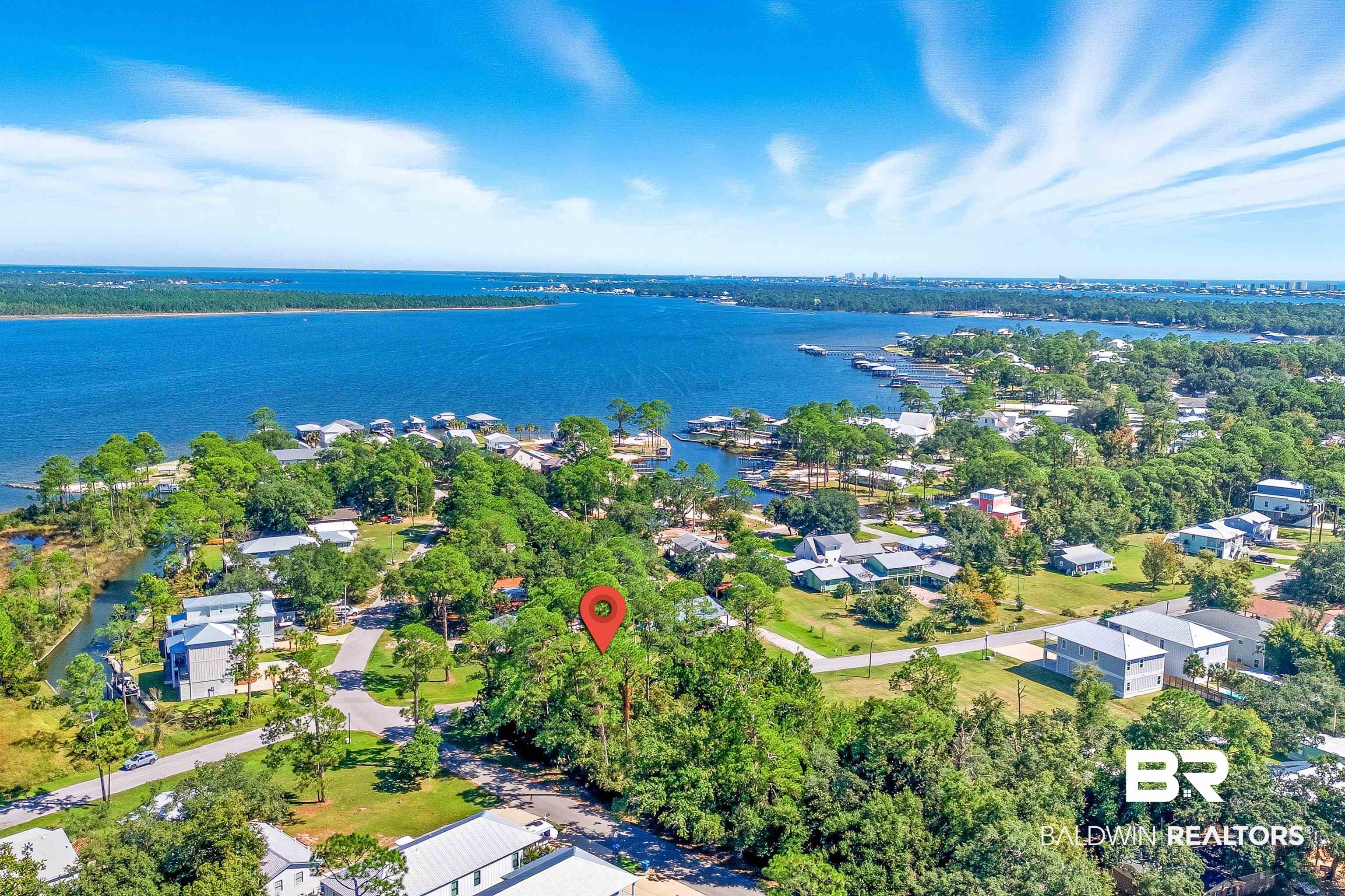 5310 Pine Road Orange Beach, AL 36561 - Photo 1 of 46 Aerial view of property's location featuring a large body of water and nearby suburban area