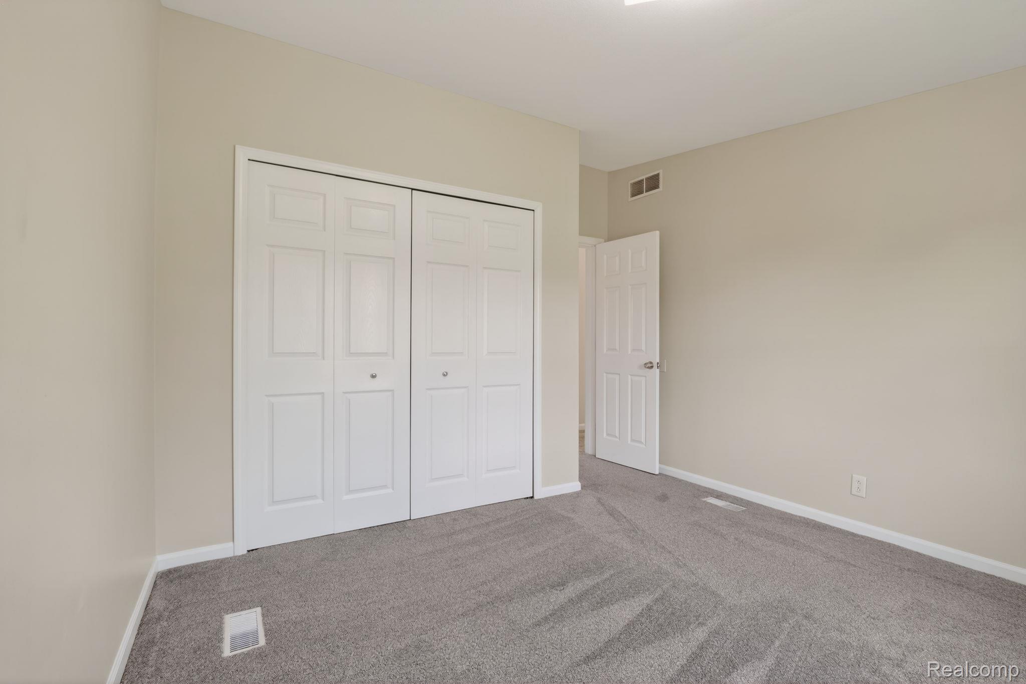 4050 West Thompson Road Linden, MI 48451 - Photo 26 of 36 Unfurnished bedroom with carpet floors and a closet