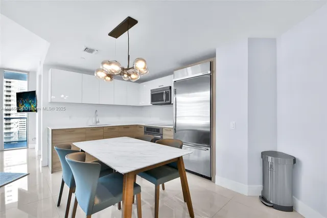 a bedroom with a bed and chandelier