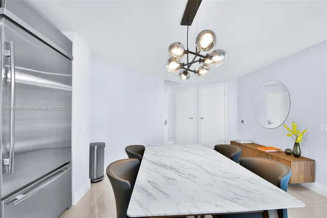 a living room with kitchen island furniture and a chandelier