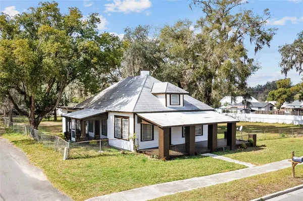 front view of a house with a yard and fountain