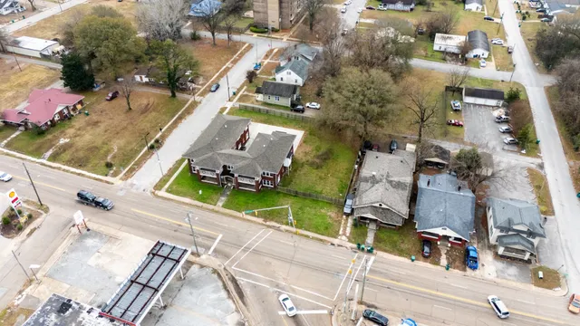an aerial view of a house with a yard and lake view