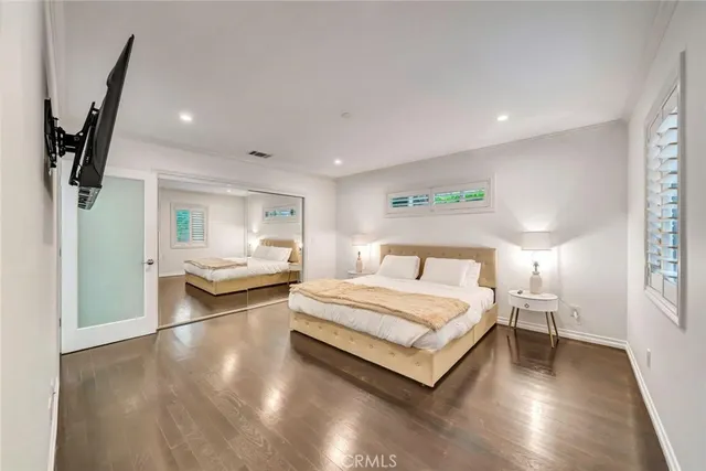 a spacious bedroom with a bed and a large window