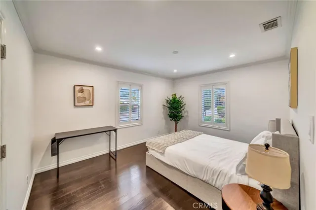 a spacious bedroom with a bed and a window