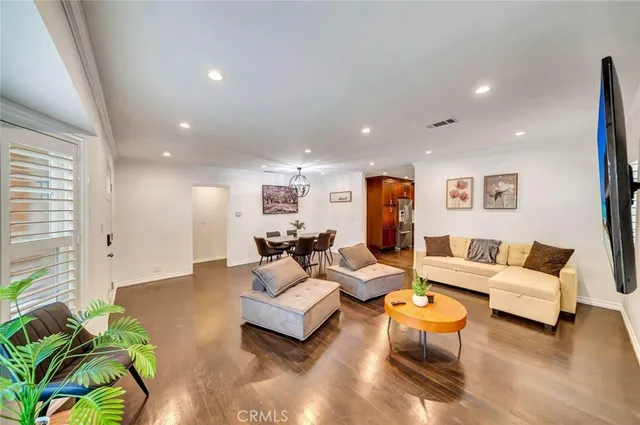 a living room with furniture and a potted plant