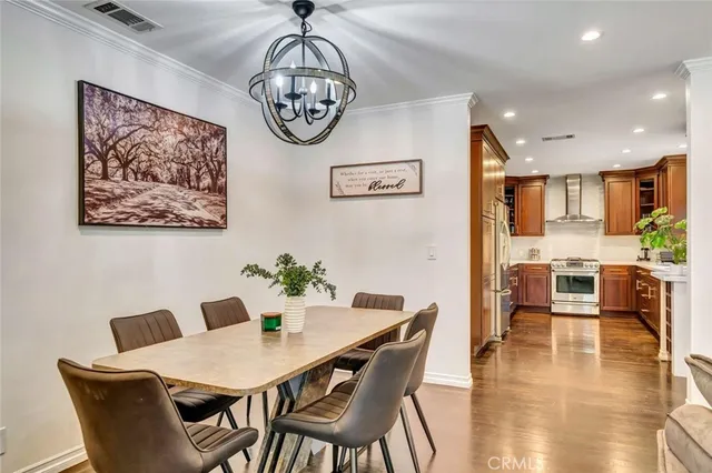 a view of a dining room with furniture wooden floor and a chandelier