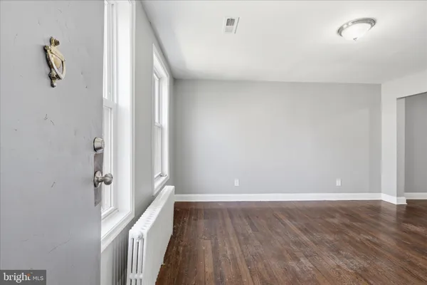 a view of room with wooden floor