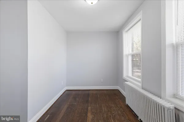 a view of a room with wooden floor and windows