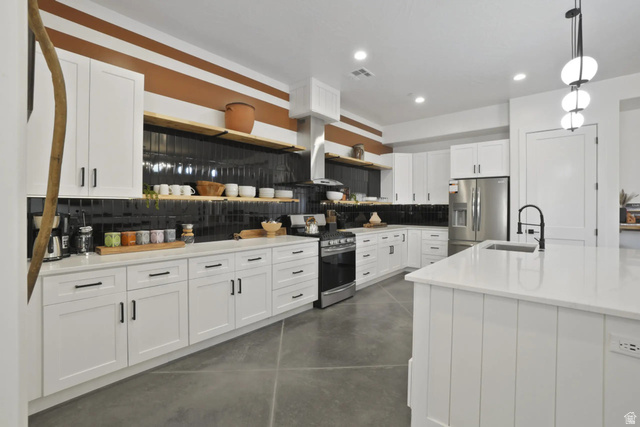 4346 Canterbury Road Hurricane, UT 84737 - Photo 4 of 37 Kitchen featuring decorative backsplash, open shelves, finished concrete flooring, stainless steel appliances, and white cabinets