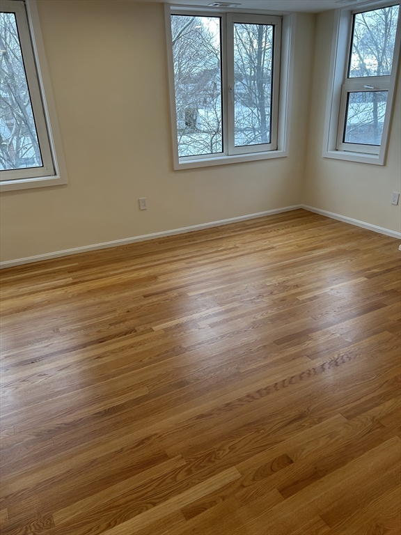 50 Main Street, Unit 409 Watertown, MA 02472 - Photo 9 of 9 an empty room with wooden floor and windows