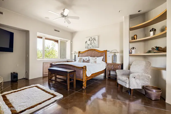 a bedroom with a bed and a bookshelf with wooden floor