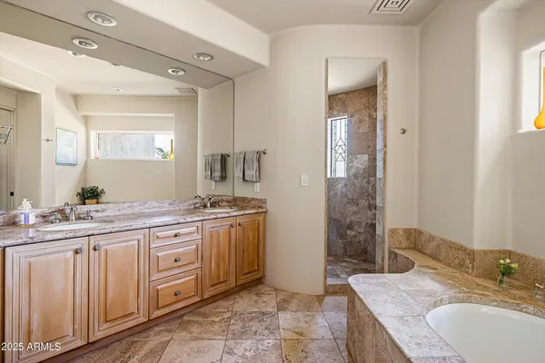 a spacious bathroom with a granite countertop sink mirror and a