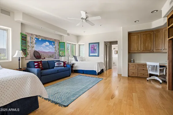 a bedroom with a bed couch and a window